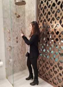 Jessica checking out a shower fixture display at the 2017 Kitchen and Bath Industry Show